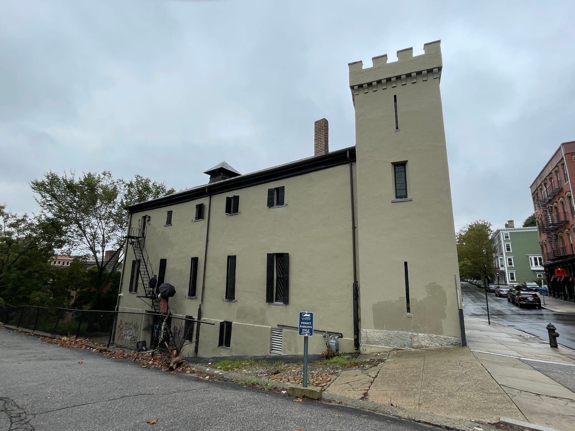 A crenellated castle-like tower building on a wet Providence street